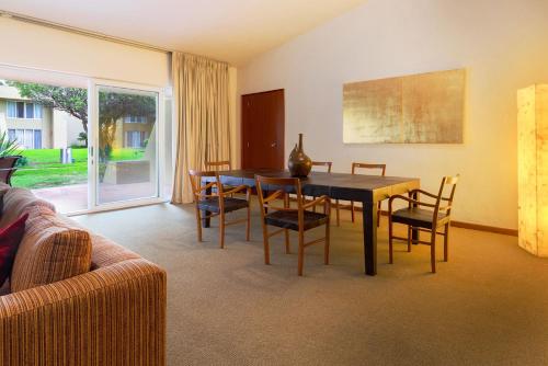 a living room with a dining room table and chairs at Camino Real Guadalajara in Guadalajara
