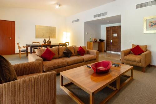 a living room with a couch and a table at Camino Real Guadalajara in Guadalajara