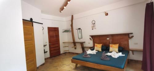 a bedroom with a bed with a blue bedspread at Sulu Sunset Beach Resort in Nauhang
