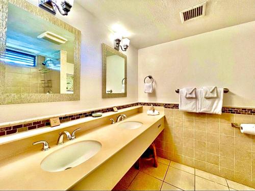 a bathroom with two sinks and a large mirror at Sapphire Beachfront Condo - View of Paradise - Free Wi - Fi C-7 in East End