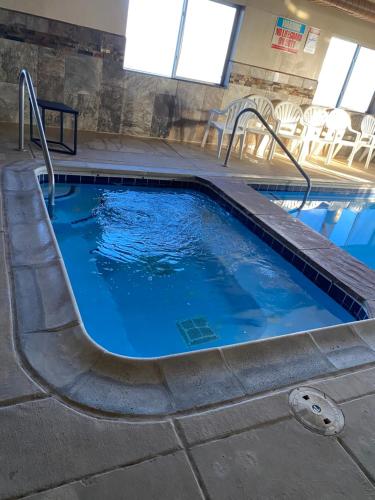 a swimming pool with blue water in a building at Comfort Inn & Suites Gunnison-Crested Butte in Gunnison
