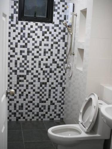 a bathroom with a toilet and a sink at M View Pool villa in Cha Am