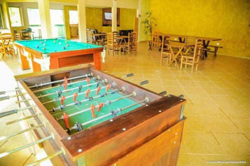 a large pool table with people on it in a room at Hotel Manoah in Socorro