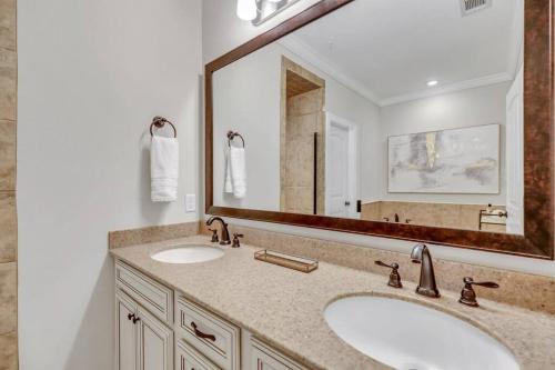 a bathroom with two sinks and a large mirror at Brand New Listing: Comfy, Stylish & Convenient South Island Townhome! in Riverview