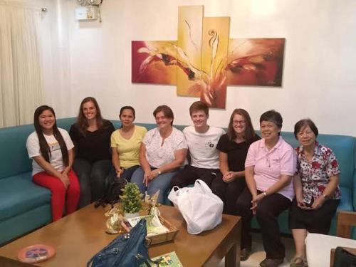 a group of people sitting on a couch at Adtempco bed and breakfast in Bangued