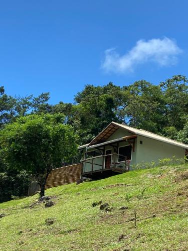 a house on top of a hill with a tree at Matha Pousada e Bistrô in Lumiar
