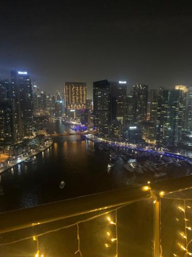 a city skyline at night with a river and buildings at ThePenthouse Coliving II in Dubai
