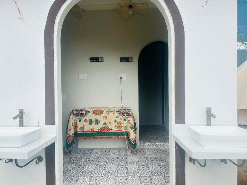 a bathroom with two sinks and a blanket on a table at Giăng's House Farmstay & Glamping in Bao Loc