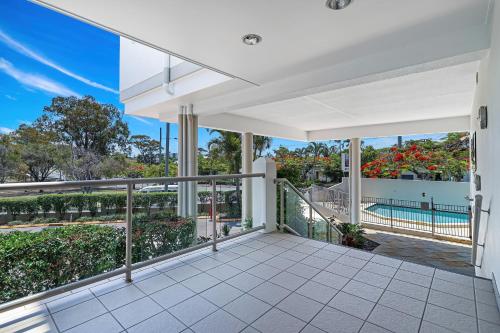 an expansive balcony with a view of a pool at La Vida on Anzac in Redcliffe
