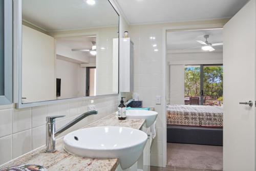 a bathroom with two sinks and a large mirror at Dream Time Direct Beach Access in Agnes Water