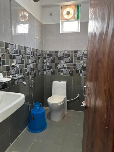 a bathroom with a toilet and a sink at UTSAV PALACE in Bodh Gaya