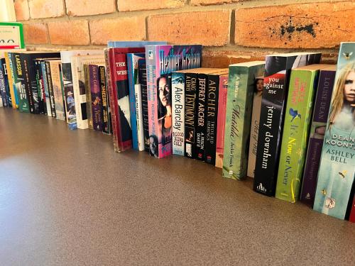 a row of books lined up on a shelf at Ocean Grove Holiday Park in Ocean Grove