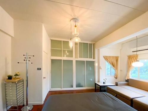 a large room with a bed and a couch at Huge Living Room + 5 bedrooms with Private baths in Bangkok