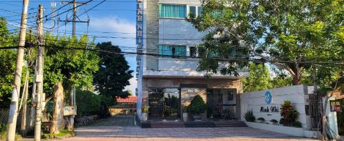 a building with a gate in front of it at Minh Nhi Hotel in La Gi