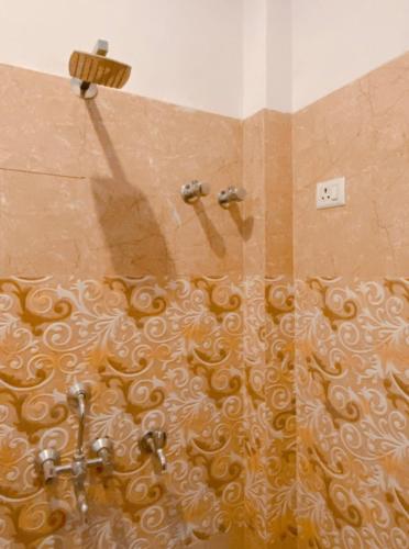 a shower in a bathroom with a shower curtain at Dreams Stay in Lucknow
