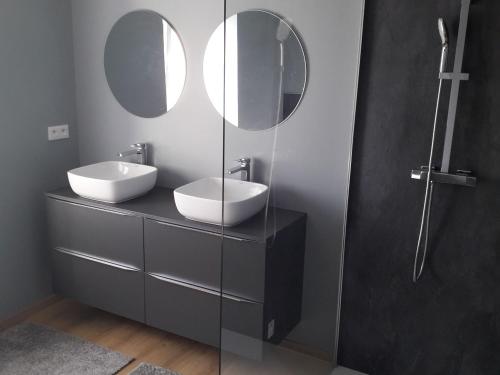 a bathroom with two sinks and two mirrors at Gîte Les Forges, 3 pièces, 6 personnes - FR-1-589-430 in Les Forges