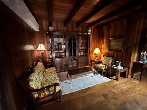 a living room with a couch and a chair at Cerro Azul Mountain Retreat in Cerro Azul