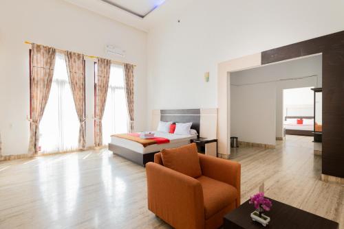 a bedroom with a bed and a chair in a room at RedDoorz Premium near Stasiun Lenteng Agung in Jakarta