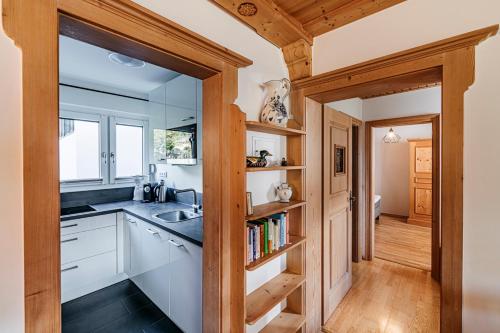 a kitchen with white cabinets and a sink at Ferienwohnung Michael - ruhig gelegen und nah am See in Schliersee