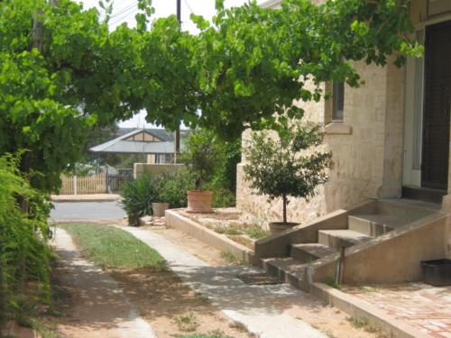 a building with a bunch of steps next to a house at Amalie Cottage Waikerie Unit 1 in Waikerie