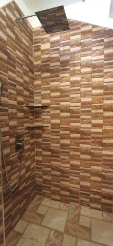 a bathroom with a shower with a wooden wall at Sulu Sunset Beach Resort in Nauhang