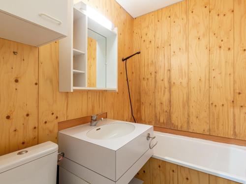 a bathroom with a sink and a toilet and a mirror at Appartement Valmorel, 2 pièces, 4 personnes - FR-1-356-330 in Valmorel