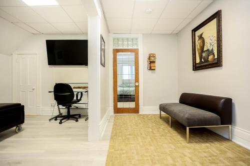 a living room with a couch and a chair at Wolseley the heart of the city ! in Winnipeg