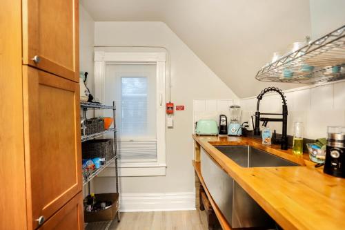 a kitchen with a sink and a counter top at Wolseley the heart of the city ! in Winnipeg