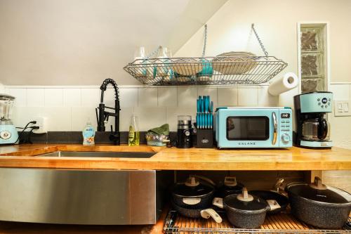 a kitchen counter with a sink and a microwave at Wolseley the heart of the city ! in Winnipeg
