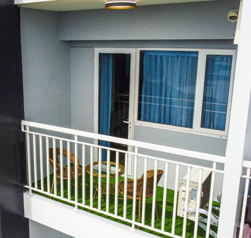 a balcony with a window and a chair at Casa Arabella - Wind Residences Tower 5 2018 in Tagaytay