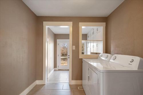 a laundry room with a washer and dryer at • Maverick House • Downtown Siloam Springs in Siloam Springs