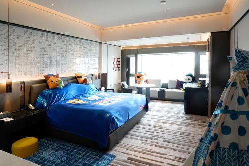 a bedroom with a bed with teddy bears on it at InterContinental Shenzhen WECC by IHG in Shenzhen