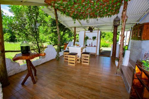 a tent with a wooden floor and a table and chairs at Amancay House in San Cristóbal