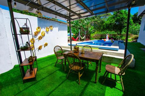 a patio with a table and chairs and a pool at Amancay House in San Cristóbal