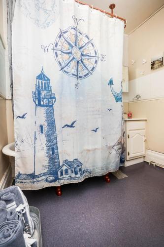 a room with a curtain with a lighthouse and a wheel at Wolseley the heart of the city ! in Winnipeg