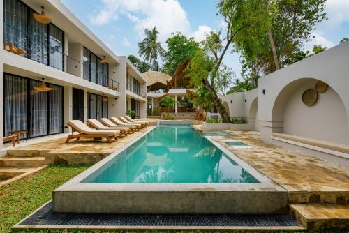 a swimming pool in the backyard of a house at Terra Resort in Ahangama
