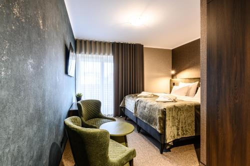 Postel nebo postele na pokoji v ubytování Ugandi Hotel