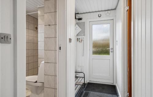 La salle de bains est pourvue de toilettes et d'une porte blanche. dans l'établissement Nice Home In Middelfart With Kitchen, à Middelfart
