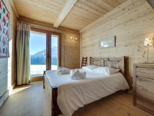 a bedroom with a bed and a large window at Chalet Montvalezan-La Rosière, 7 pièces, 14 personnes - FR-1-690-22 in Montvalezan