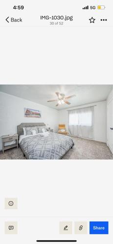 a bedroom with a bed and a ceiling fan at Del Mar pool Home in Fresno