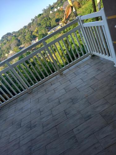 a balcony with a fence and a view of a mountain at Queens and king2 in Pinetown