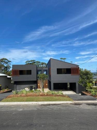 a house on the side of a street at Hyams Beach House B - Brand new lux beach oasis in Hyams Beach