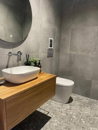 a bathroom with a sink and a toilet at Hyams Beach House B - Brand new lux beach oasis in Hyams Beach