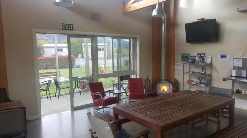 a dining room with a wooden table and chairs at Murchison Motorhome Park in Murchison