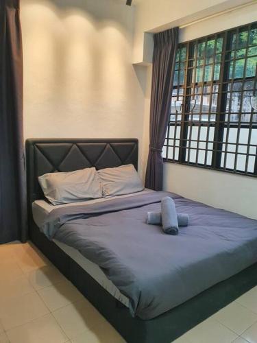 a bed in a room with a window at 3 Storey Bangalow near Spice Arena & Queensbay Mall in Bayan Lepas