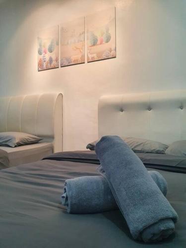 a stuffed animal laying on top of a bed at 3 Storey Bangalow near Spice Arena & Queensbay Mall in Bayan Lepas
