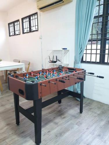 a foosball table sitting in the middle of a room at 3 Storey Bangalow near Spice Arena & Queensbay Mall in Bayan Lepas