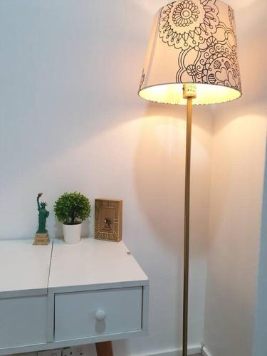 a lamp sitting on top of a white dresser at 3 Storey Bangalow near Spice Arena & Queensbay Mall in Bayan Lepas