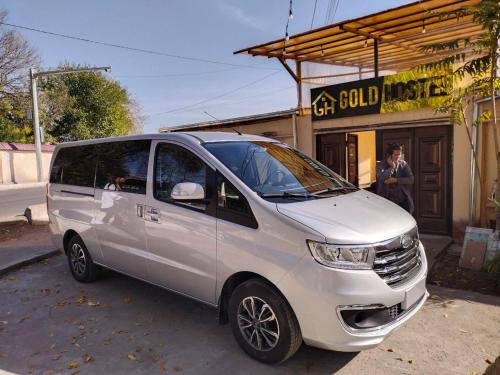 a white van parked in front of a store at Gold Hostel in Tashkent