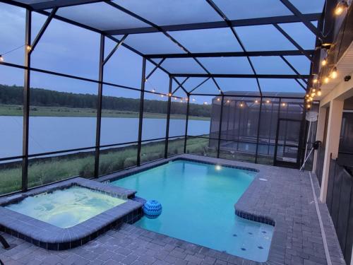 a swimming pool in a house with a view of a river at Winterfield Storey Lakeview 4173 in Kissimmee